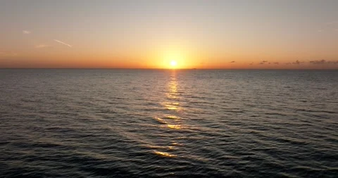 The sunset paints the sky over the tranquil lake with a warm afterglow Stock Footage 276090027
