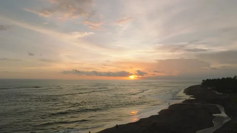 The sunset paints the sky over the tranquil ocean with a warm afterglow Stock Footage 280251250