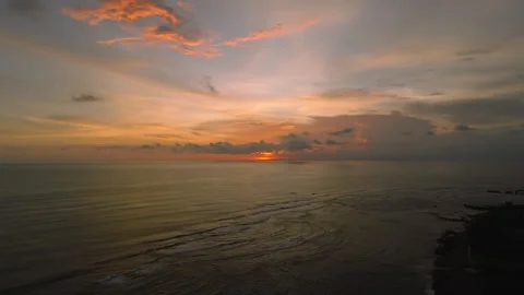 The sunset paints the sky over the tranquil ocean with a warm afterglow Stock Footage 280251262