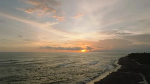 The sunset paints the sky over the tranquil ocean with a warm afterglow Stock Footage 280772383