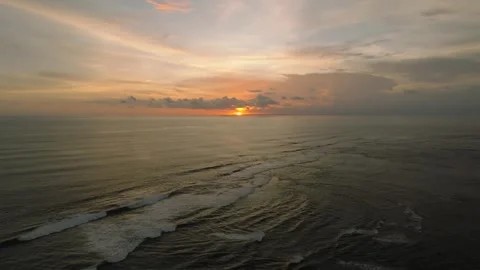 The sunset paints the sky over the tranquil ocean with a warm afterglow Stock Footage 280966662