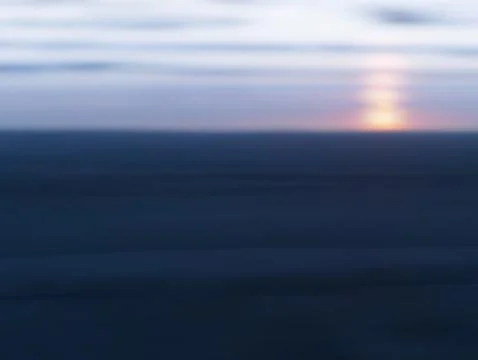 Sunset on pale blurred beach Stock Photos