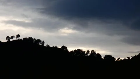 Sunset pale light behind clouds. Winter in the mountains. 4k P1120617 Stock Photos