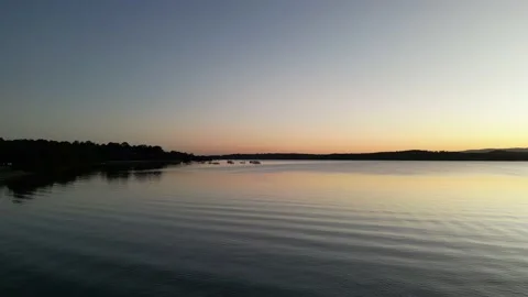 Sunset panning shot flying over the lake. Stock Footage 208925369