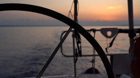 Sunset panorama from behind the steering wheel of a sailing yacht Stock Footage 120258708