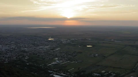 Sunset with a panorama of the city in the plain and a medieval tower Stockbeeldmateriaal 138025137