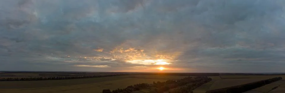 Sunset panorama with cloudy sky Stock Photos