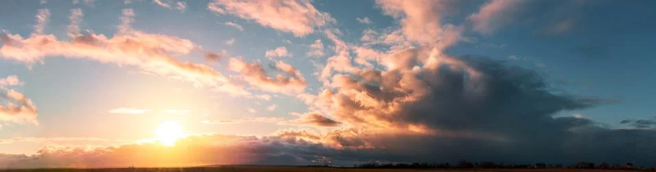 Sunset panorama with large clouds Stock Photos