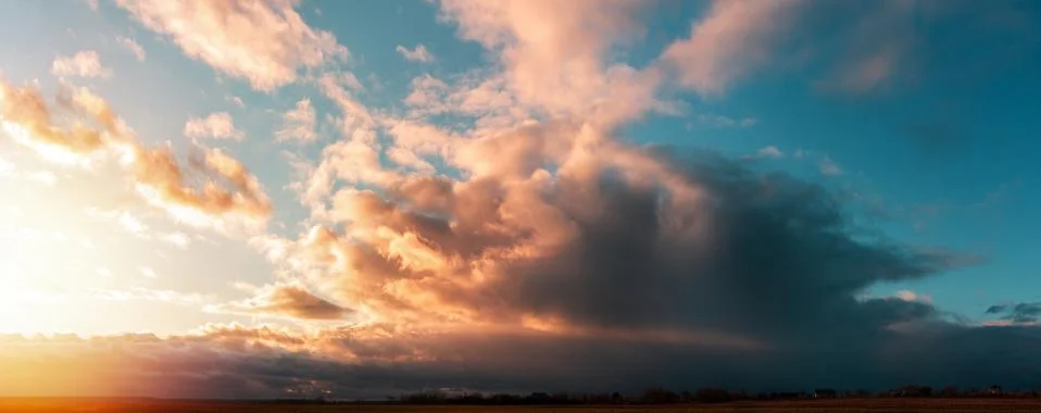 Sunset panorama with large clouds Stock Photos