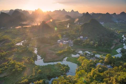 Sunset with a panoramic view on the river, village and the limestone mounta.. Stock Photos