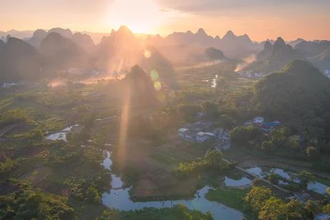 Sunset with a panoramic view on the river, village and the limestone mounta.. Stock Photos