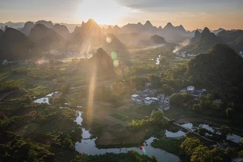 Sunset with a panoramic view on the river, village and the limestone mounta.. Stock Photos