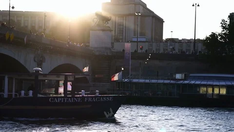 Sunset Paris, boat under bridge of Seine river. French flag.  Stock Footage 125495464