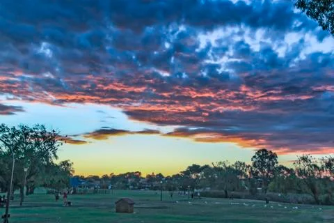Sunset at a park with dark clouds suggesting a storm coming Stock Photos