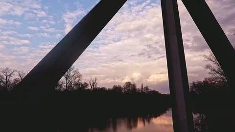 Sunset in the park with the river, the sky reflected in the water Stock Footage 125930750