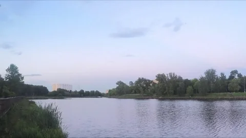 Sunset in park on the shore of the pond timelapse Stock Footage 79807972