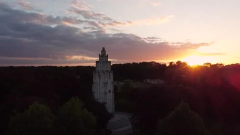 Sunset in a park with a statue Stock Footage