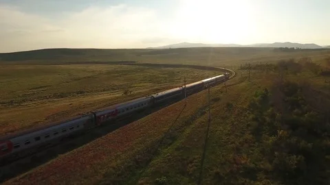 Sunset passengers train ride steppe Rails Russia Buryatia Aerial drone 4k        Stock-Footage 74961346