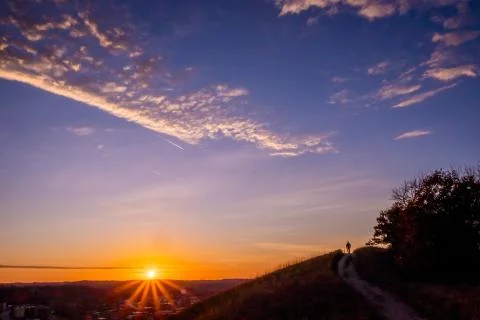 Sunset with path and walker Stock Photos