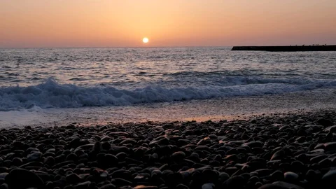 Sunset on the pebble sea beach. Stock Footage 105187443