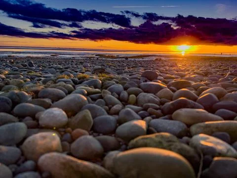 Sunset on Pebbled Beach Stock Photos