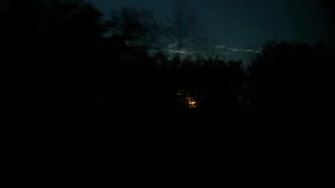The Sunset peeks through the Trees as the Train speeds past Stock Footage 92650964
