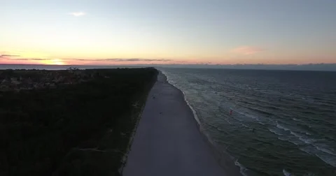 Sunset at peninsula, aerial video, camera backwards, birds fly by Stock Footage 68010123