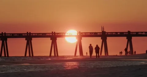 Sunset At Pensacola Beach Pier with the Silhouette of Tourists Stock Footage