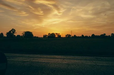 Sunset on the plain, among the trees Stock Photos