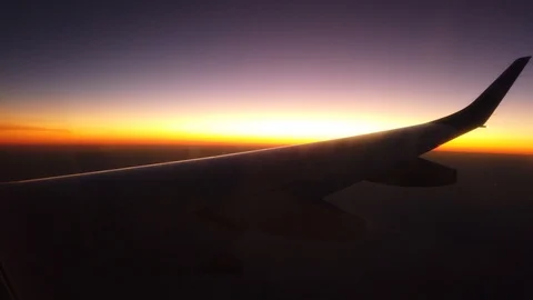 Sunset from a plane point of view. Airplane wings in central perspective Stock Footage 116730391