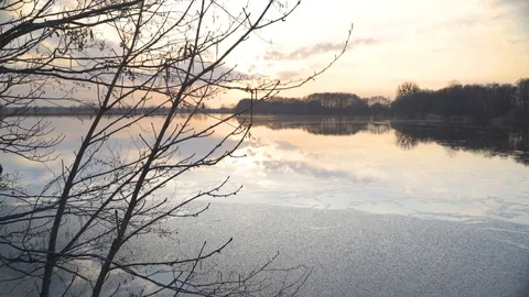 Sunset at the pond at the turn of winter and spring Stock Footage 107086166