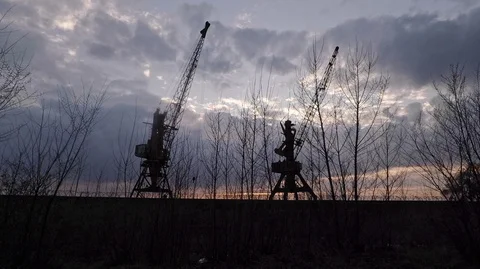 Sunset in the port against the cloudy sky two large cranes Stock Footage 125931427