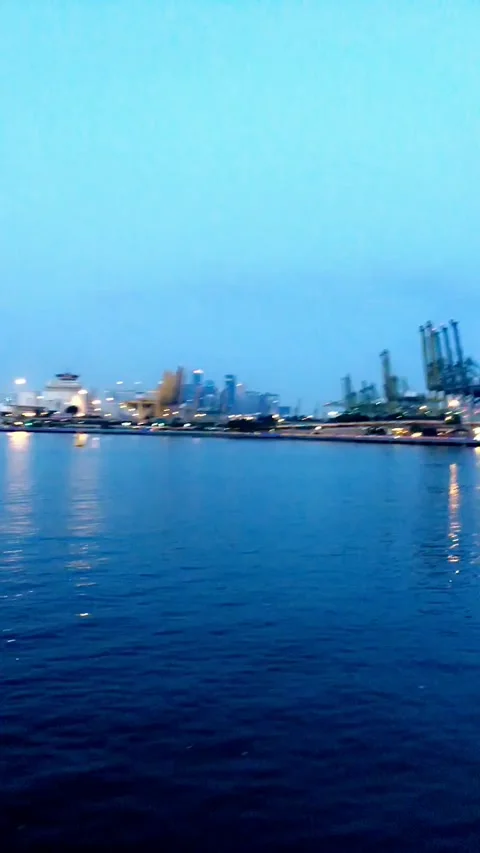 Sunset at port on a cloudy day lightning Stock Footage 137047781