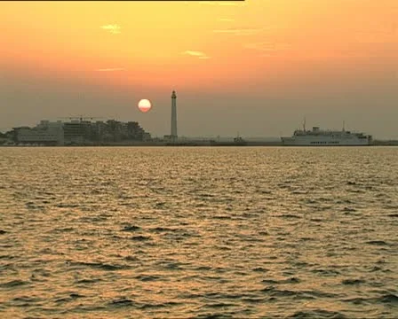 SUNSET at port with lighthouse long shot Video stock 11401787