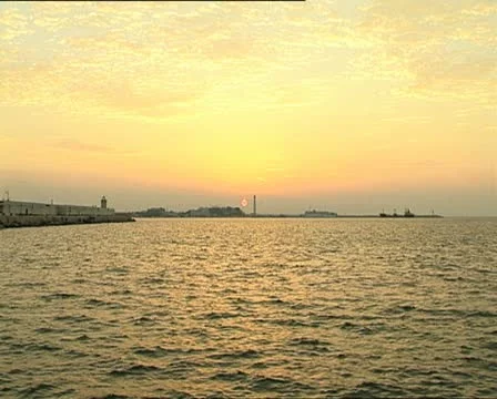 SUNSET at port with lighthouse zoom Video stock 11401424