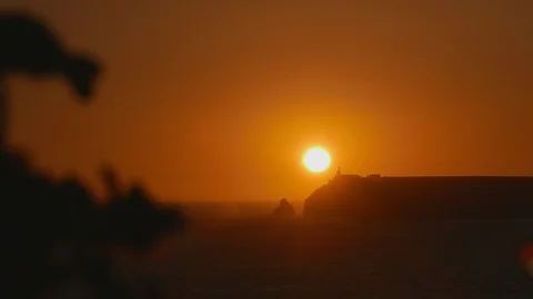 Sunset in Portugal behind lighthouse Stock Footage 119070189