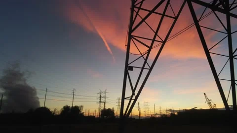Sunset by power towers -- Drone camera moves right Stock Footage 141421082