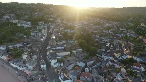 Sunset pull out from Lyme Regis over sea Dorset Jurassic coast aerial 4k Stock Footage 197406929