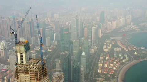 Sunset qingdao skyscraper construction top crane high aerial panorama 4k china Stock Footage 135793388