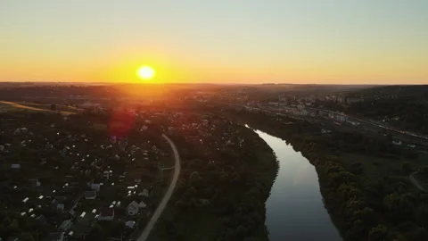 Sunset, the quadcopter flies to the setting sun over the river Stock Footage 167393446