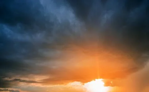 Sunset with rain and dark clouds. Sunshine, sun, rays. 写真素材