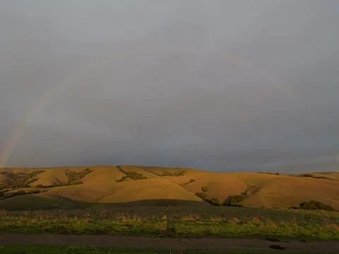 Sunset rainbow after light rain Stock Photos