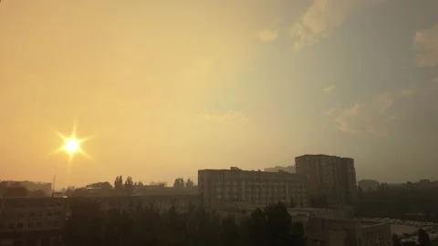 Sunset Rainfall in City with Subtle Rain and Sun Rays on a Summer Evening Video stock 313740069