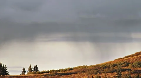 Sunset Rainfall on Distant Hill Stock Footage 8807940
