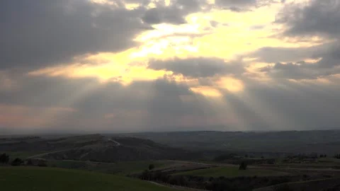 Sunset rays break through clouds above continental fields before rainfall Stock Footage 339375565