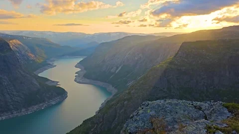 Sunset Rays Over the Mountain Edge: A Breathtaking View of the Lake Stock Footage 282398446