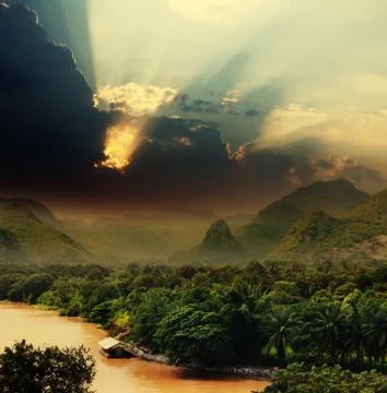 Sunset with rays over river Stock Photos