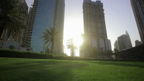 Sunset rays pass between glass skyscrapers in central Dubai Stockbeeldmateriaal 155601232