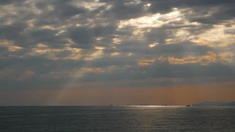 Sunset with rays through clouds over the sea Video stock 130265069