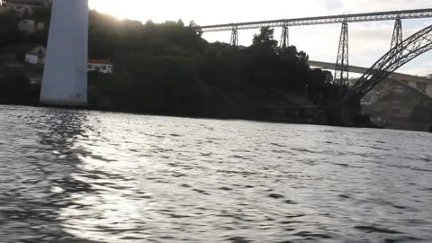 Sunset rays under a bridge in river Douro, Porto Stock Footage 319353886